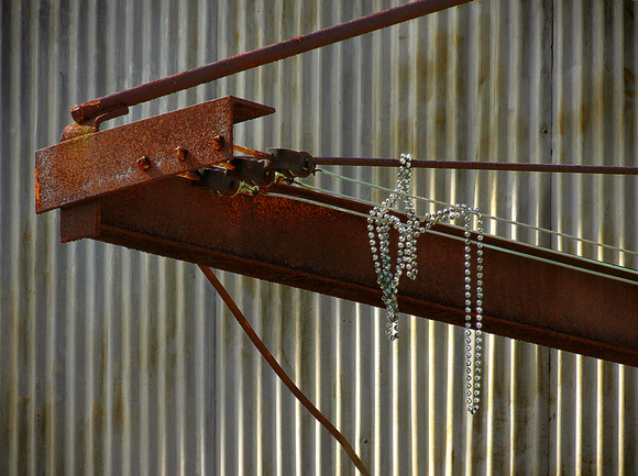 Mardi Gras Beads on Rusty Object